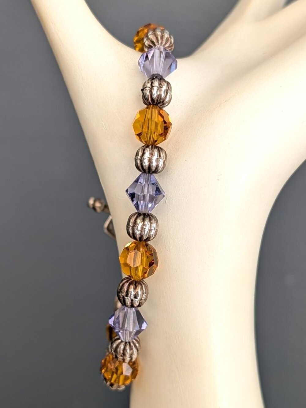 Orange and purple faceted glass beads with silver bead accent bracelet